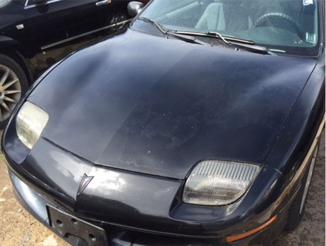 car paint oxidation. faded and oxidized car paint. These photos show the result of applying L'Oxide Oxide Reducing Emulsion to the hood of a black Pontiac Sunfire suffering from severe clear coat failure and peeling.